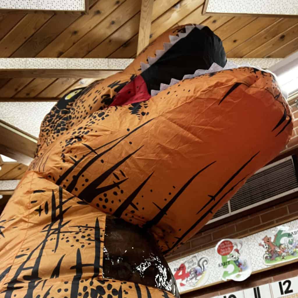 Blow Up T-rex dinosaur head worn by Ms Davis in her Classroom.